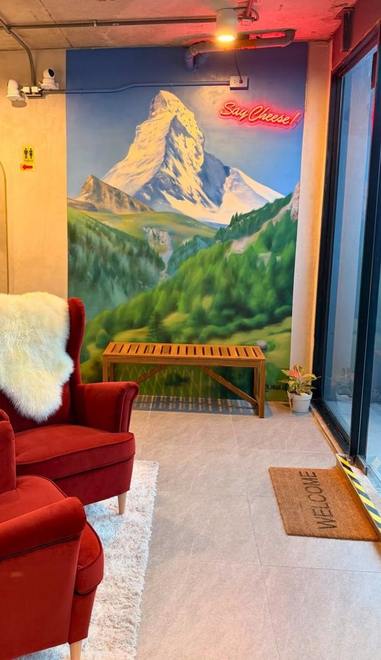 The entrance, with a painted Matterhorn mural and a neon Say Cheese sign